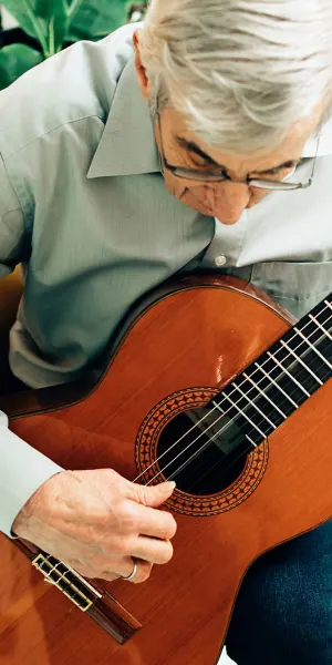 Older man playing guitar