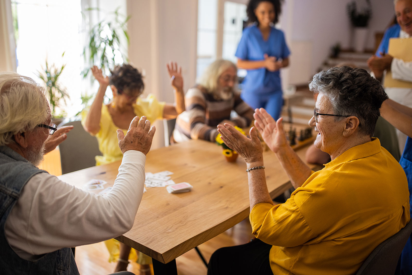 Elderly people enjoying a lively game with caregivers.