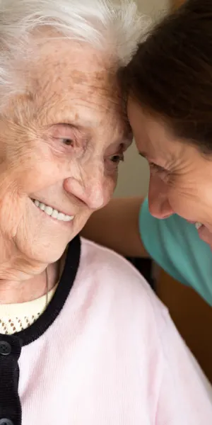 A joyful moment between two smiling women.